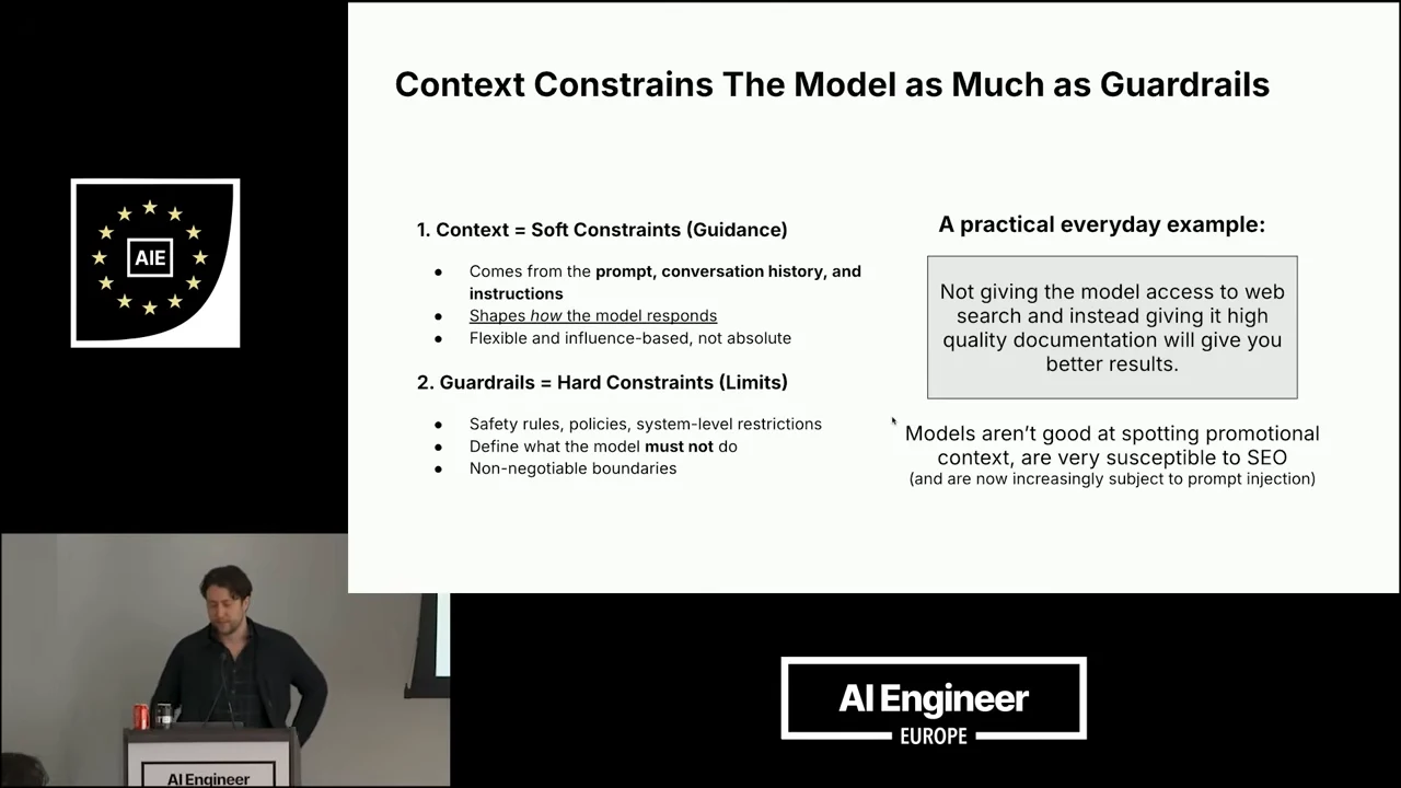 Two-column slide contrasts context as guidance with guardrails as limits, alongside an example of supplying high-quality documentation instead of web search and warnings about promotional content, SEO, and prompt injection.