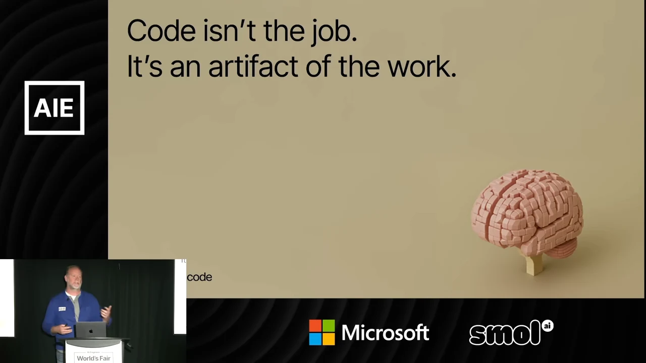A beige slide pairs the statement about code being an artifact of work with a pink brain built from toy bricks.
