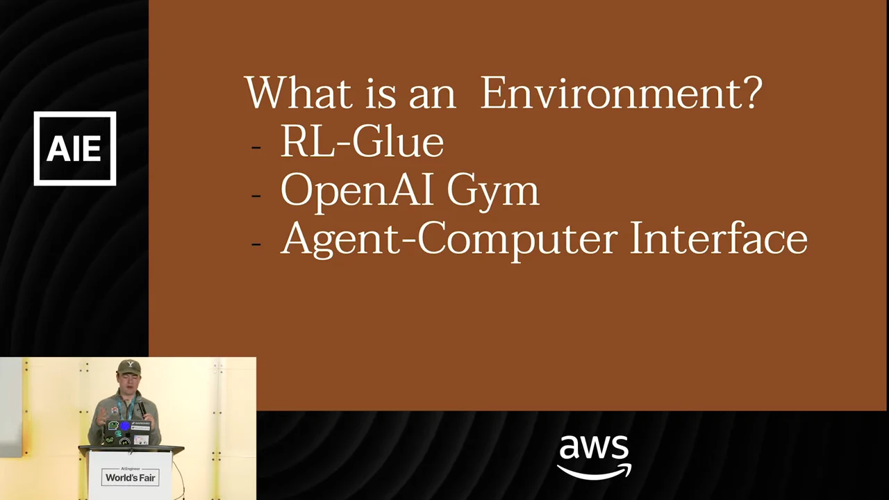 Slide titled “What is an Environment?” lists RL-Glue, OpenAI Gym, and Agent-Computer Interface, with the speaker inset below.