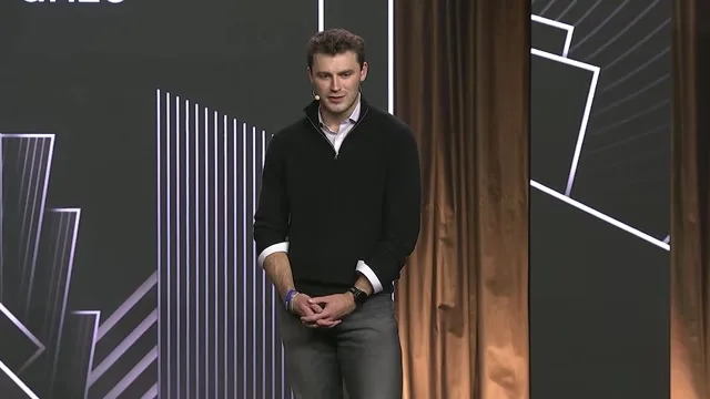 Jack McDonald onstage during his introduction provides a speaker portrait for the essay.