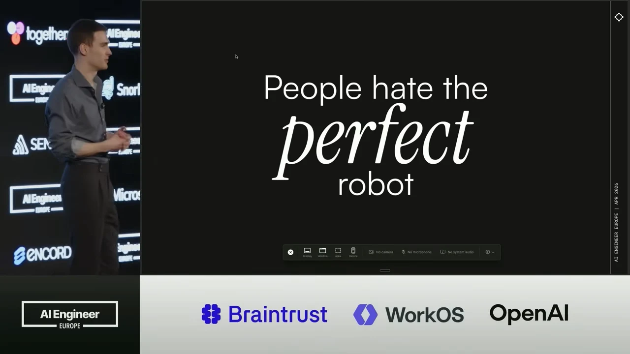 Black slide reading “People hate the perfect robot,” with “perfect” enlarged in italic type and the speaker at left.