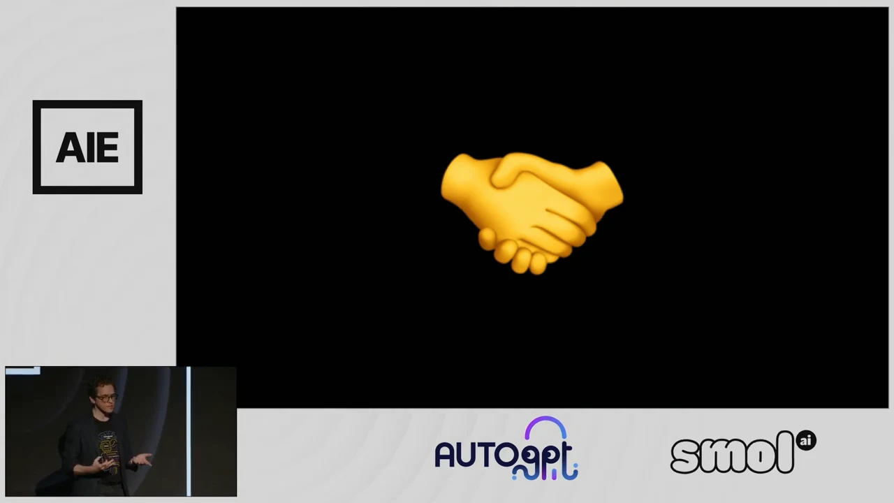 Yellow handshake emoji centered on a black slide, with a speaker inset and conference and sponsor branding.