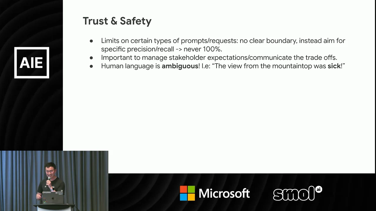 Trust & Safety slide listing precision and recall limits, stakeholder expectations and language ambiguity, illustrated by “The view from the mountaintop was sick!”