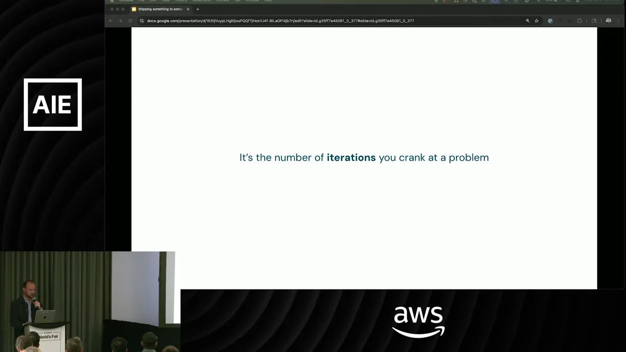 White slide with a centered sentence emphasizing “iterations,” alongside a speaker inset.