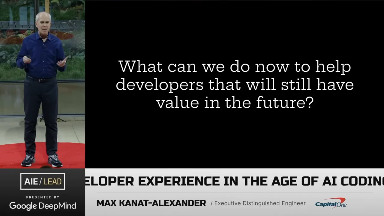 Presenter beside a black slide asking what work to help developers now will still have value in the future.