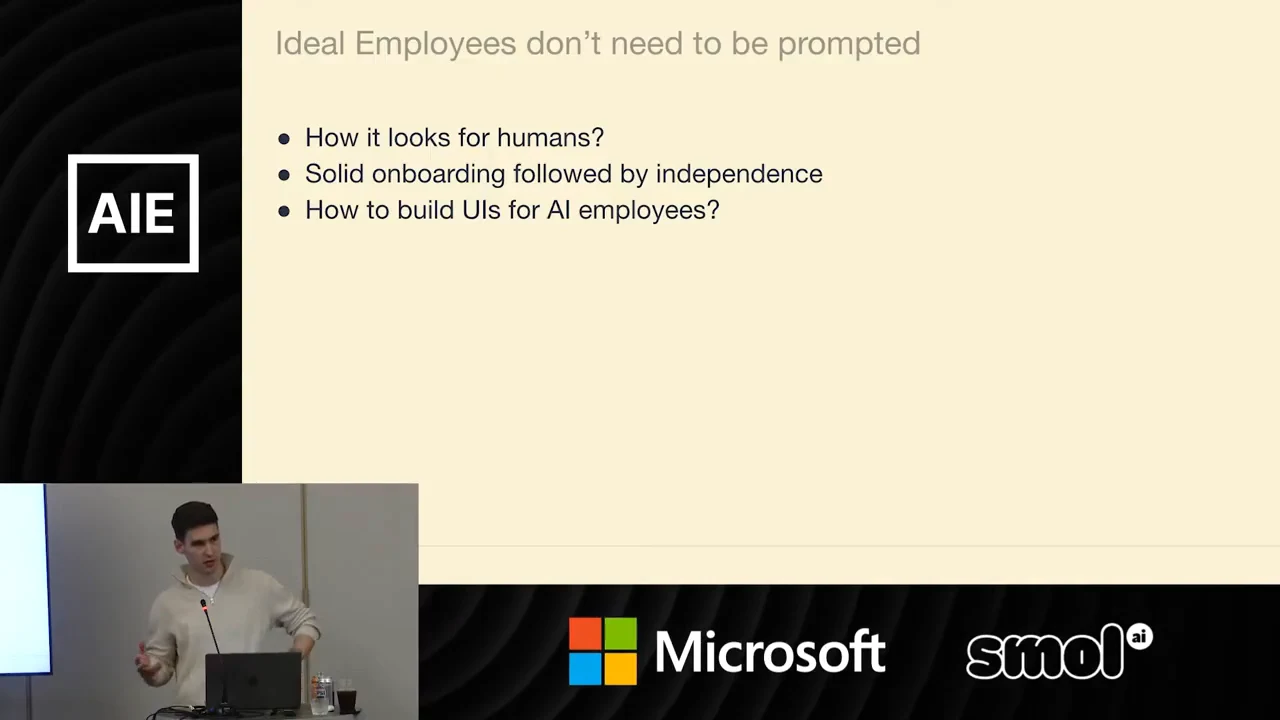 Slide lists human employees, solid onboarding followed by independence, and building UIs for AI employees, with the presenter inset below.