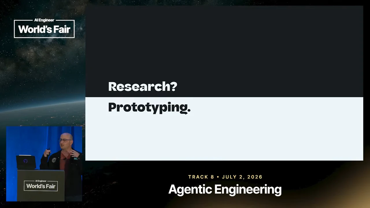 A two-tone slide reads “Research?” above “Prototyping.” with the presenter inset at lower left.