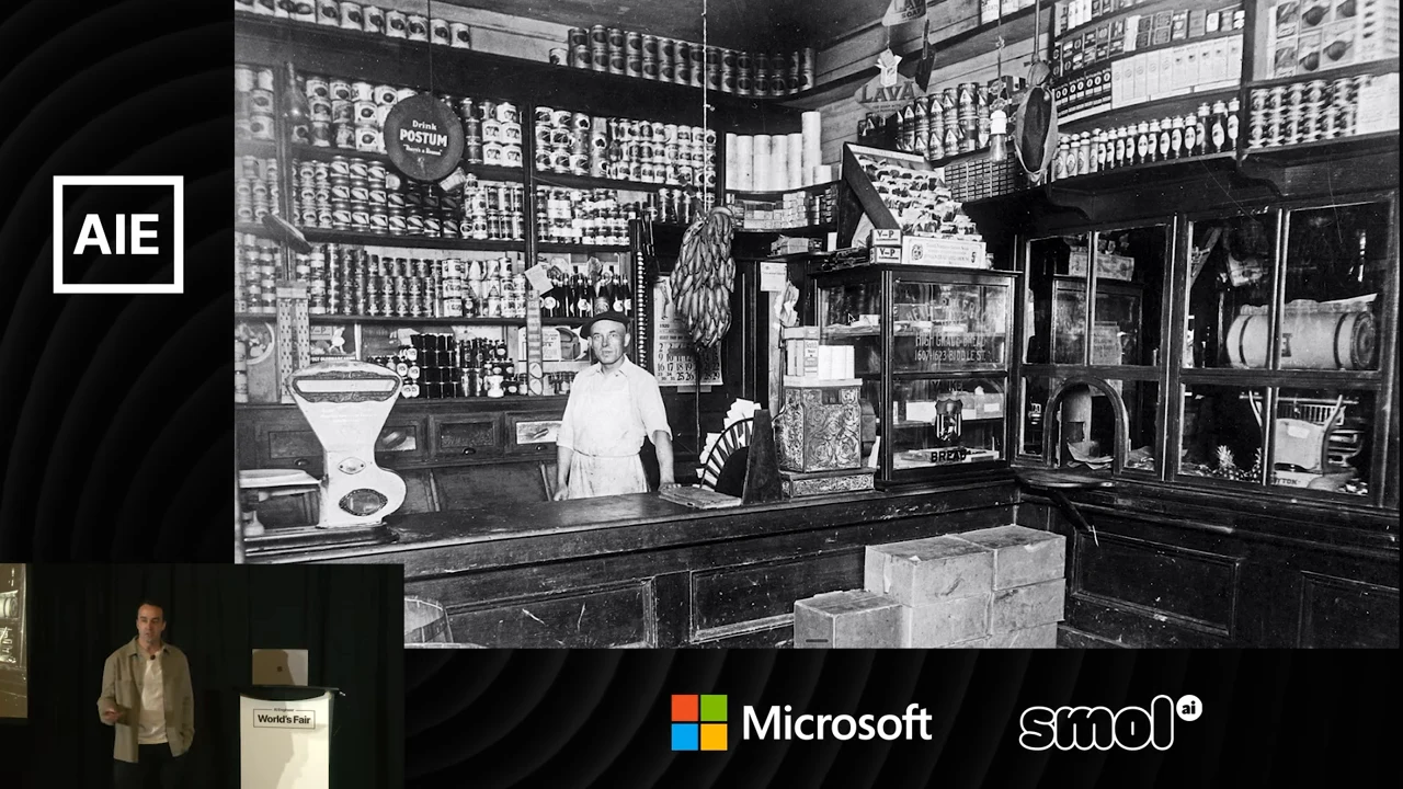 Black-and-white photograph of a clerk behind a wooden counter, surrounded by shelves of packaged goods.