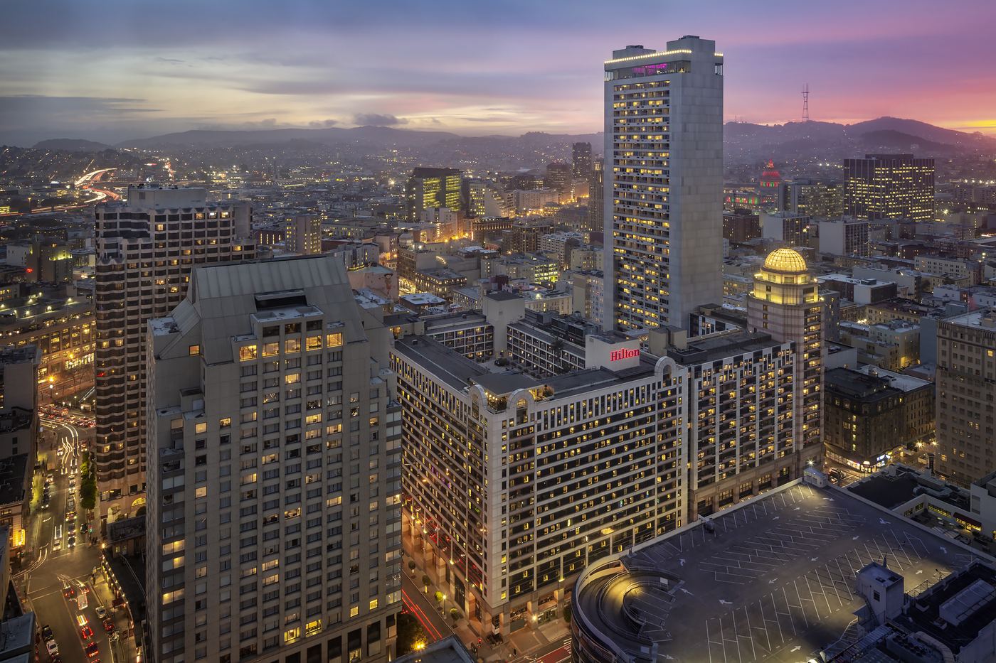 Hilton San Francisco Union Square at dusk, seen from above the surrounding downtown skyline